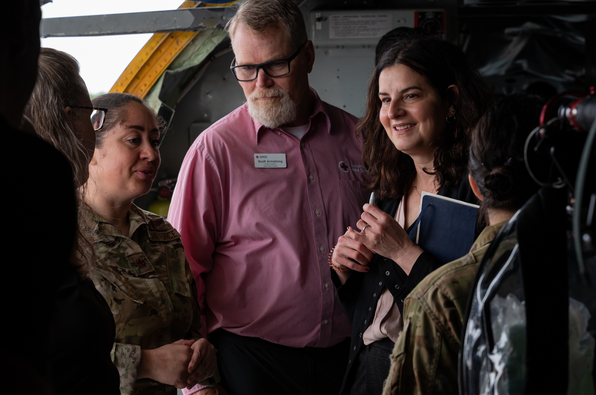 Five people talk with each other inside of a KC-135 Stratotanker.