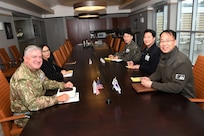 British Commodore Jonathan Lett, U.S. Indo-Pacific Command J-5 Deputy Director for Policy (left) meets with Brig. Gen. Kyoung-suk Woo, representing the Republic of Korea Ministry of Defense (right), and staff members on March 4, 2025 at the Camp Withycombe Armed Forces Readiness Center in Happy Valley, Oregon.