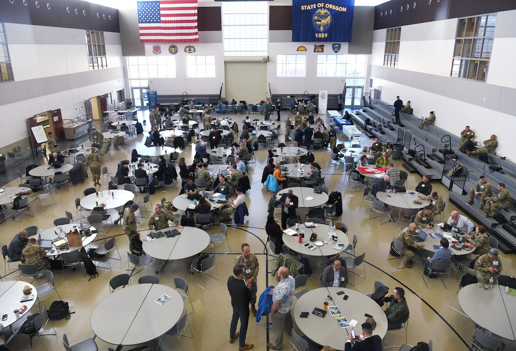 Participants of U.S. Indo-Pacific Command’s Capabilities Development Working Group engage in discussions and meetings on the drill floor of Camp Withycombe’s Armed Forces Readiness Center in Happy Valley, Oregon on March 6, 2025.