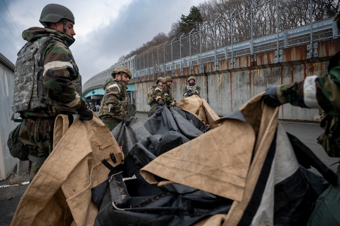 U.S. Air Force Airmen, assigned to the 35th Fighter Wing Mission Ready Airman (MRA) program, move a tent cover during spoke teardown as part of the Beverly Sunrise 25-03 exercise at Misawa Air Base, Japan, March 18, 2025.