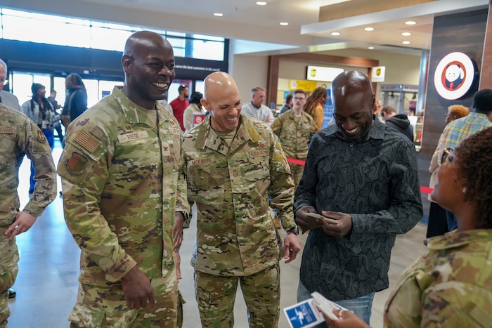 Col. Deedrick Reese, left, Robins Installation and 78th Air Base Wing commander, and Chief Master Sgt. Lloyd Morales, center, 78th ABW command chief, thank Chris Smith, 78th ABW safety office occupational safety and health manager, for his charitable Air Force Assistance Fund donation at the base exchange at Robins Air Force Base, Georgia, March 17, 2025.