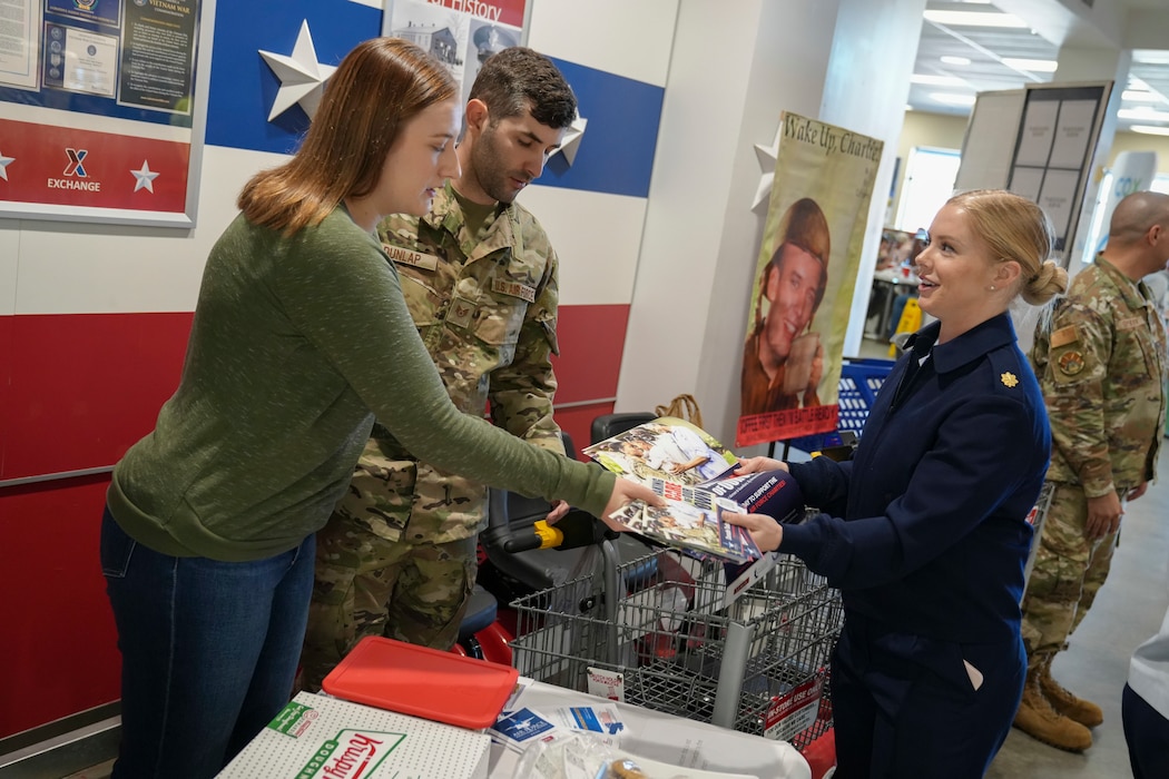 Woman handing pamphlets to volunteers 