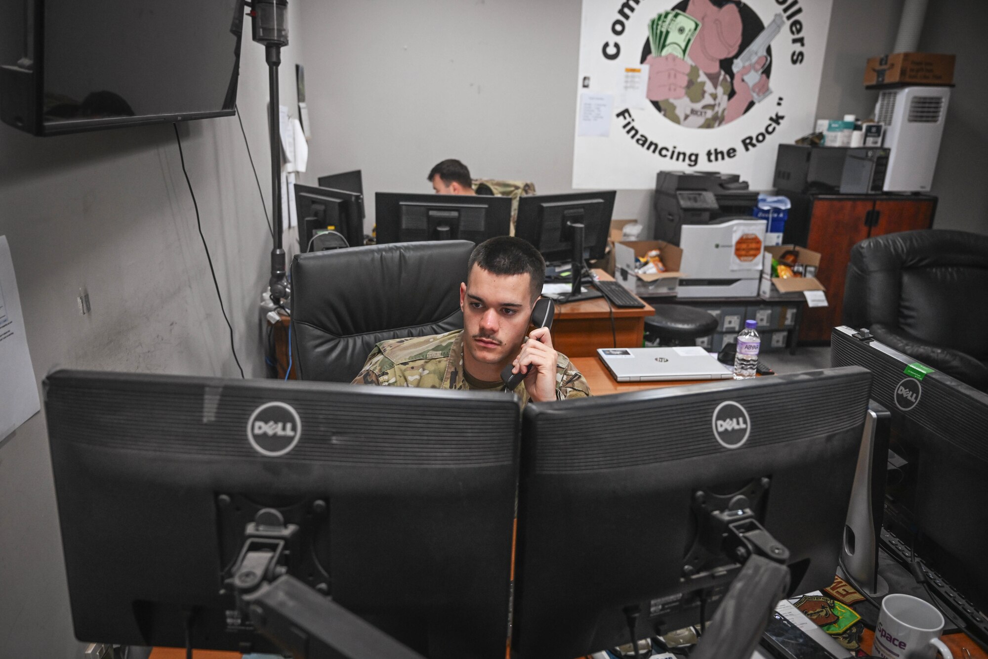 A man in uniform speaks on the phone.