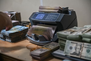 A cash counting machine cycles through cash.