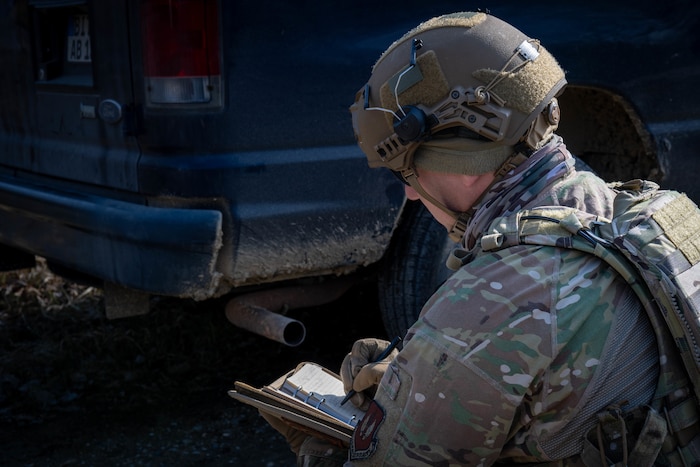 U.S. Air Force member writes in a notepad.