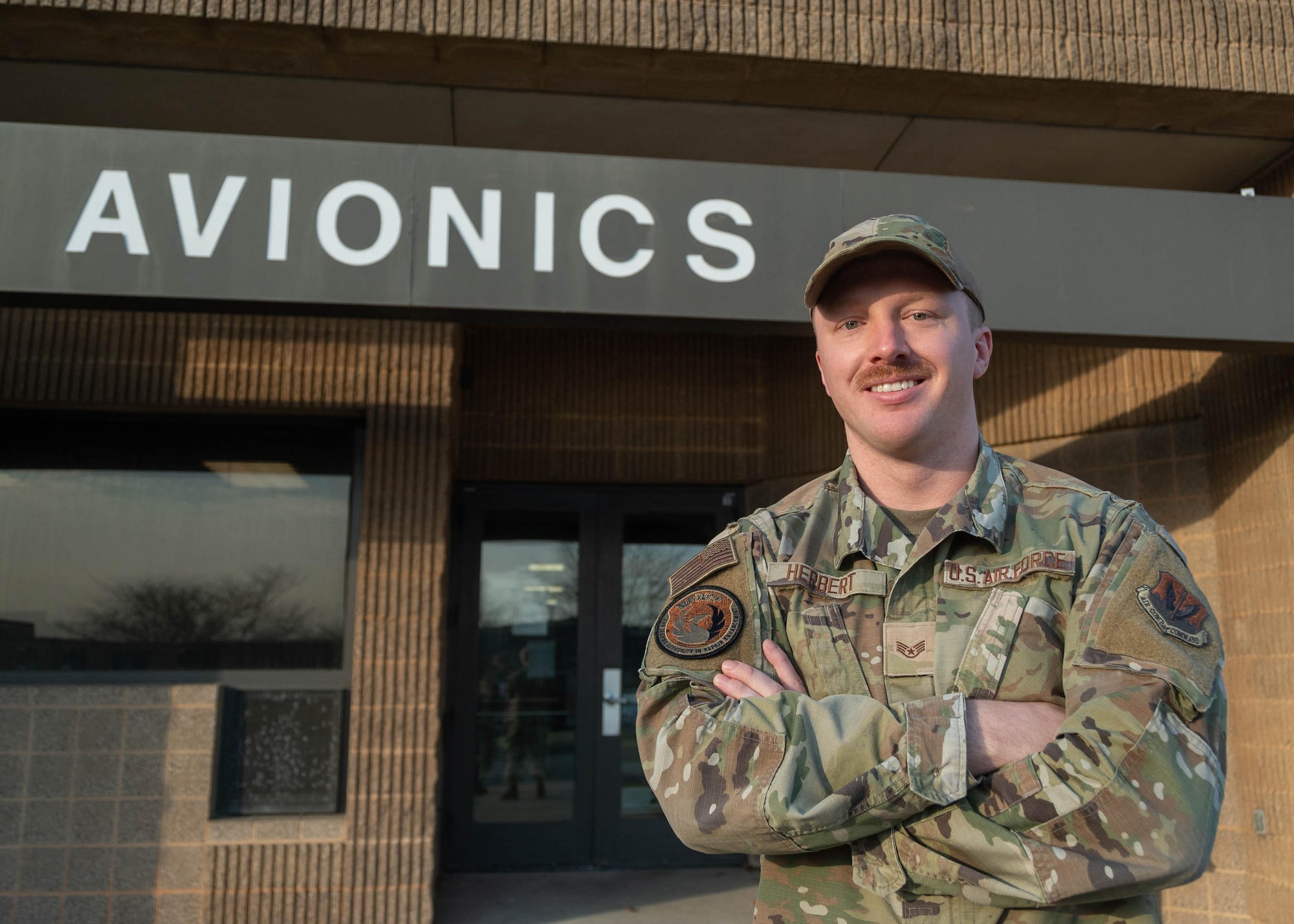 Maryland Air National Guard Staff Sgt. Derek Herbert, avionics test station and components technician for the 175th Maintenance Squadron, poses outside of the Avionics building at Warfield Air National Guard Base at Martin State Airport, Maryland, March 20, 2024.