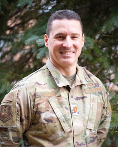 A man in uniform posing for a photo.