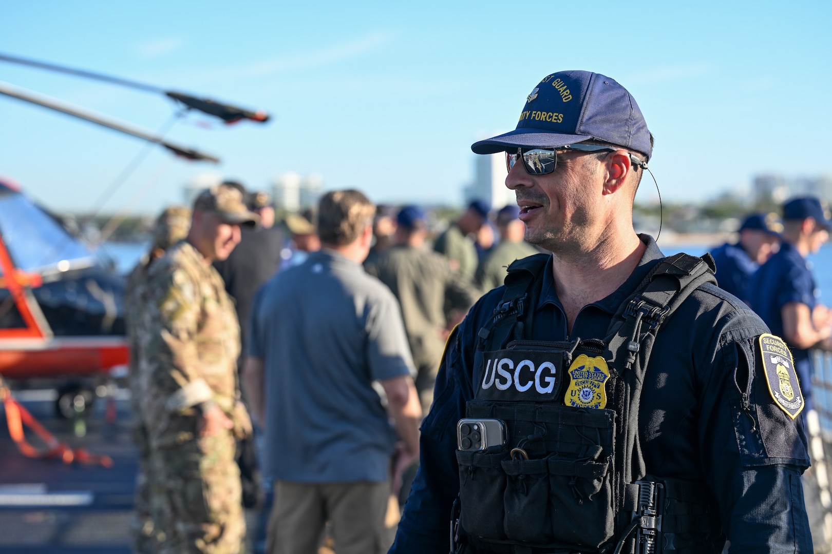 A crew member aboard the Coast Guard Cutter Stone standing watch over illicit narcotics at Port Everglades, on March 20, 2025. Armed Coast Guardsmen stand watch over interdicted drugs to ensure security and accountability of seized contraband. (U.S. Coast Guard photo by Petty Officer 3rd Class Nicholas Strasburg)