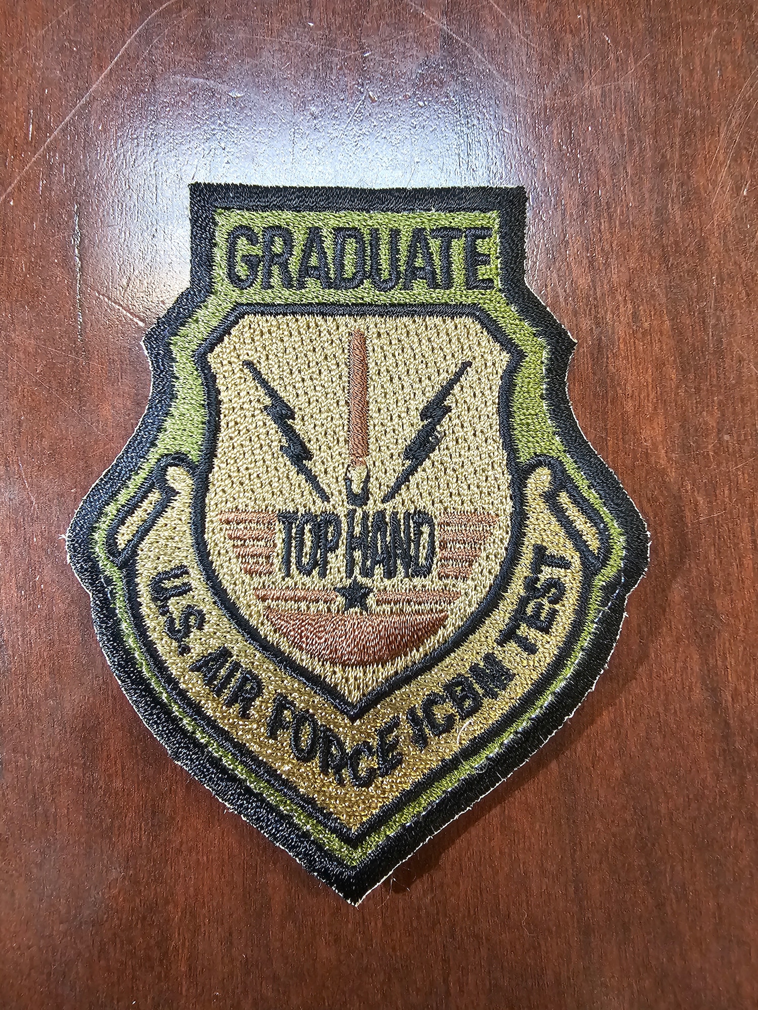 Military men in uniform at small graduation ceremony