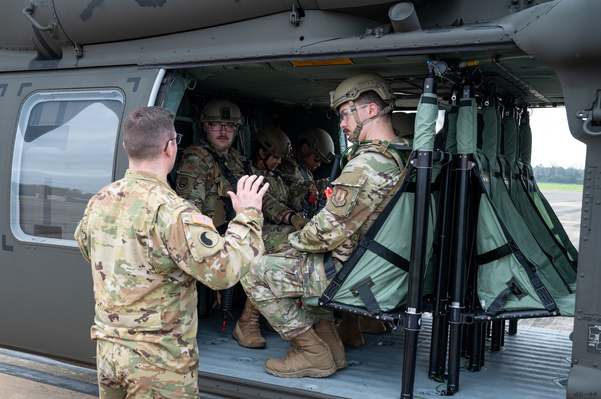 U.S. Army Sgt. Mitchell Dees, 1-131st Aviation Regiment aircraft mechanic, explains egress training procedures to Airmen on a U.S. Army UH-60 Black Hawk at Maxwell Air Force Base, Alabama, March 14, 2025.