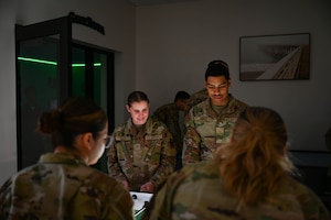 U.S. Airman 1st Class Julia Lao, 81st Medical Support Squadron medical records technician, and Airman 1st Class Chris Abreu, 81st Surgical Operations Squadron medical technician, play foosball during the Larcher Chapel grand re-opening.