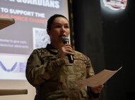 U.S. Air Force Captain Brianna Kelley,  69th Bomber Squadron weapon systems officer, delivers opening remarks at the 2025 Air Force Assistance Fund campaign kickoff at Minot Air Force Base, North Dakota, March 19, 2025. The Air Force Assistance Fund campaign is an annual event that raises money for charities supporting Airmen and their families when in need. (U.S. Air Force photo by Airman 1st Class Wesley Davies)