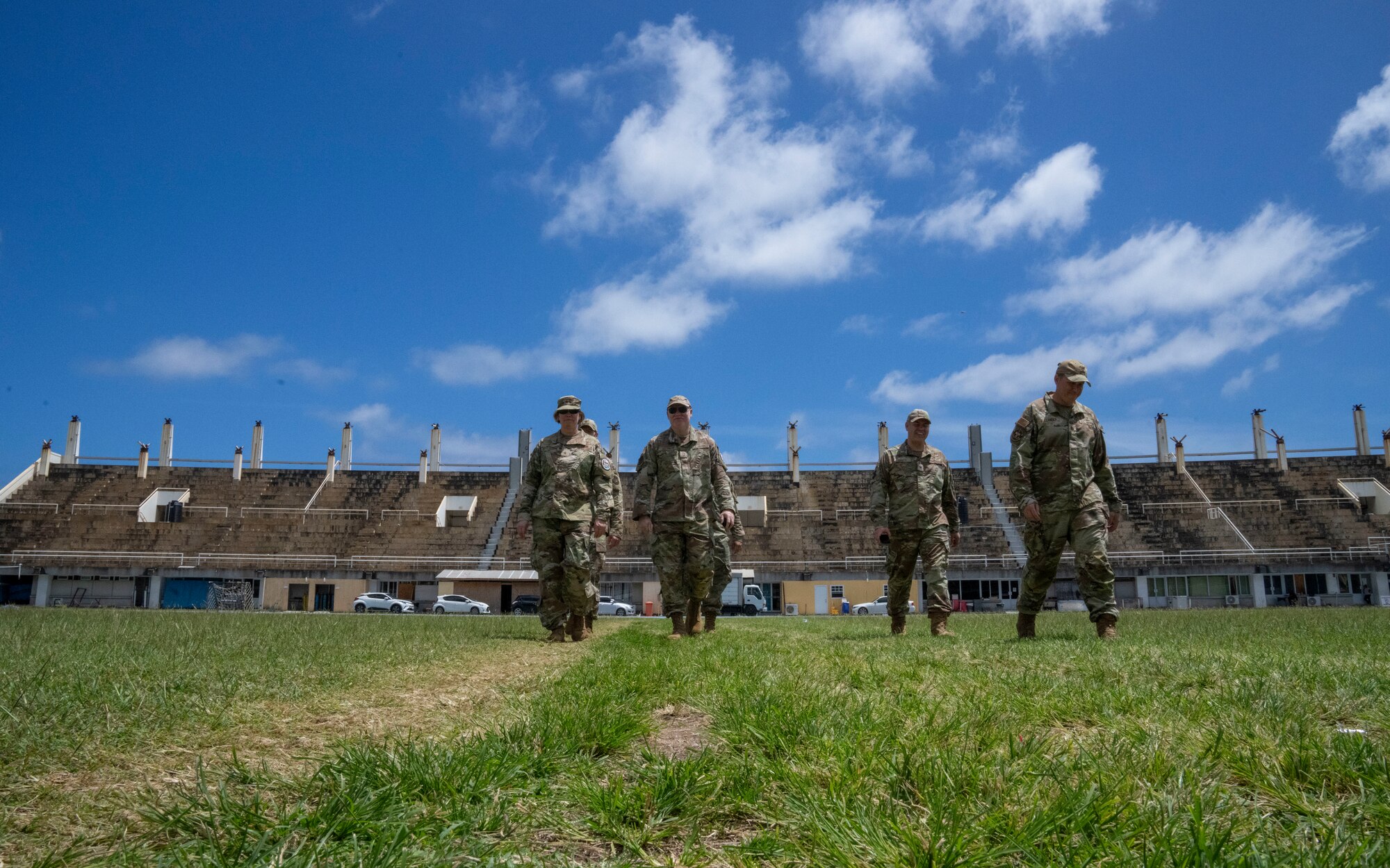 U.S. Air Force Brig. Gen. Tara Nolan, Mobilization Augmentee to the Air Forces Southern commander, and members of Lesser Antilles Medical Assistance Team walk across a field at St. Jude Hospital in Vieux Fort, Saint Lucia, March 6, 2025. A fire in 2009 forced a relocation of the St. Jude hospital's essential services to the George Odlum Stadium. (U.S Air Force photo by Andrea Jenkins)