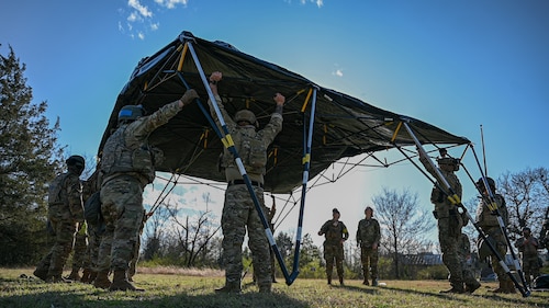 Airmen assigned to the 19th Civil Engineer Squadron assemble a Base-X tent during a Prime Base Engineer Emergency Force (Prime BEEF) field training exercise at Little Rock Air Force Base, Arkansas, March 19, 2025. The exercise focused on base establishment, perimeter security, defensive fighting positions and shelter construction.