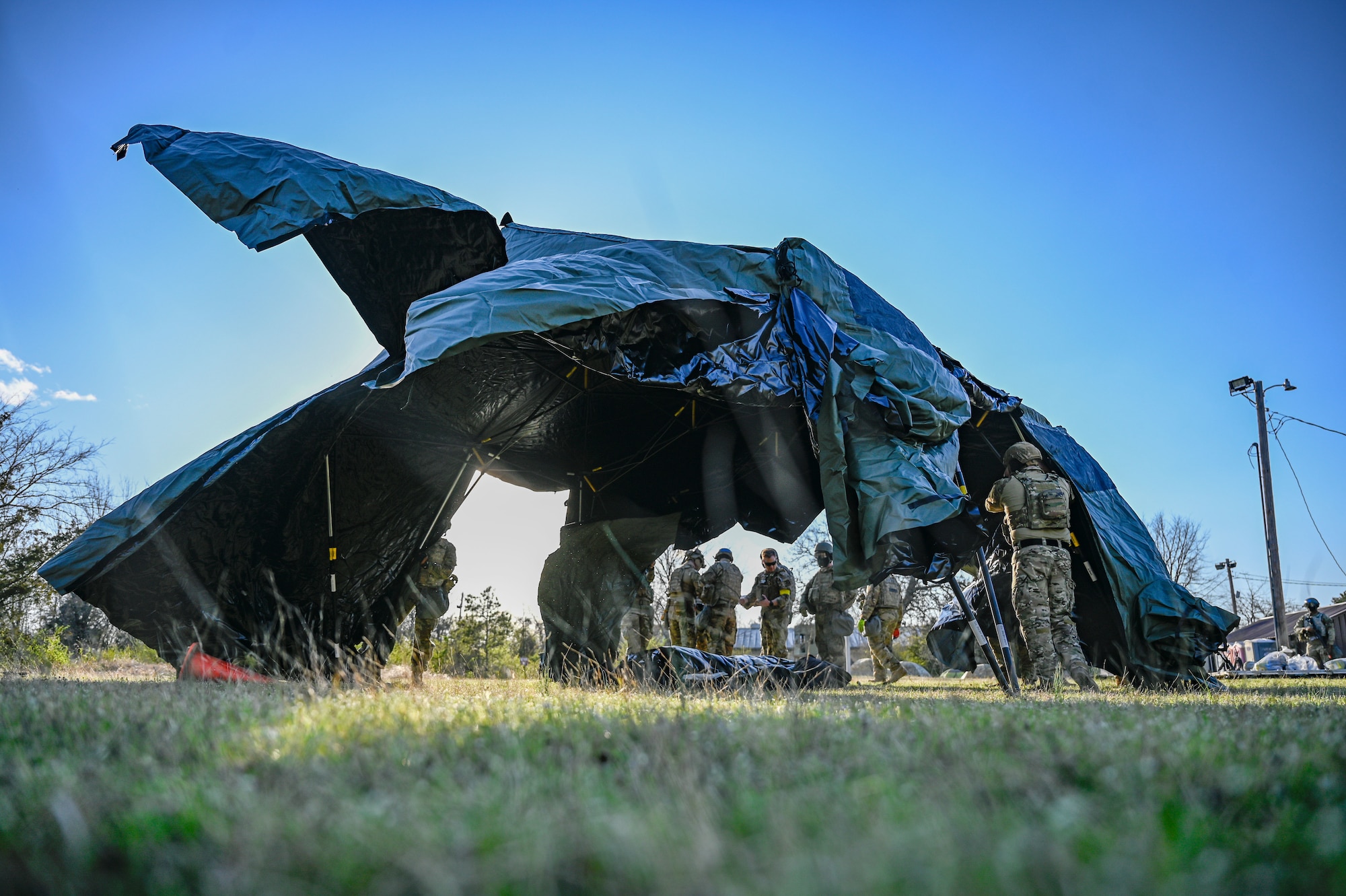 Airmen assigned to the 19th Civil Engineer Squadron assemble a Base-X tent during a Prime Base Engineer Emergency Force (Prime BEEF) field training exercise at Little Rock Air Force Base, Arkansas, March 19, 2025. Through hands-on experience, Airmen learned how to troubleshoot and repair essential systems under challenging and hostile conditions.