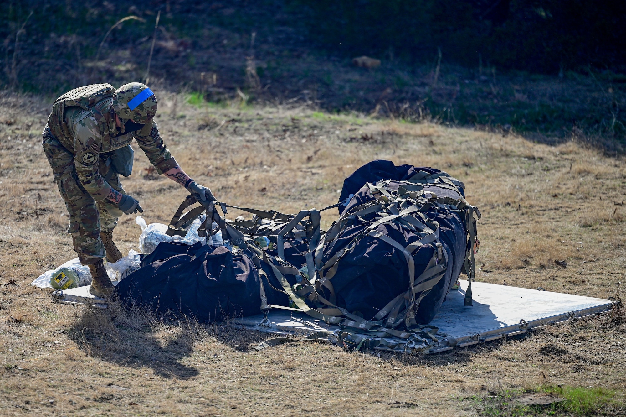 An Airman assigned to the 19th Civil Engineer Squadron retrieves an equipment airdrop during a Prime Base Engineer Emergency Force (Prime BEEF) field training exercise at Little Rock Air Force Base, Arkansas, March 19, 2025. Prime BEEF reinforced the importance of teamwork and communication, both of which are critical for mission success in deployed environments.