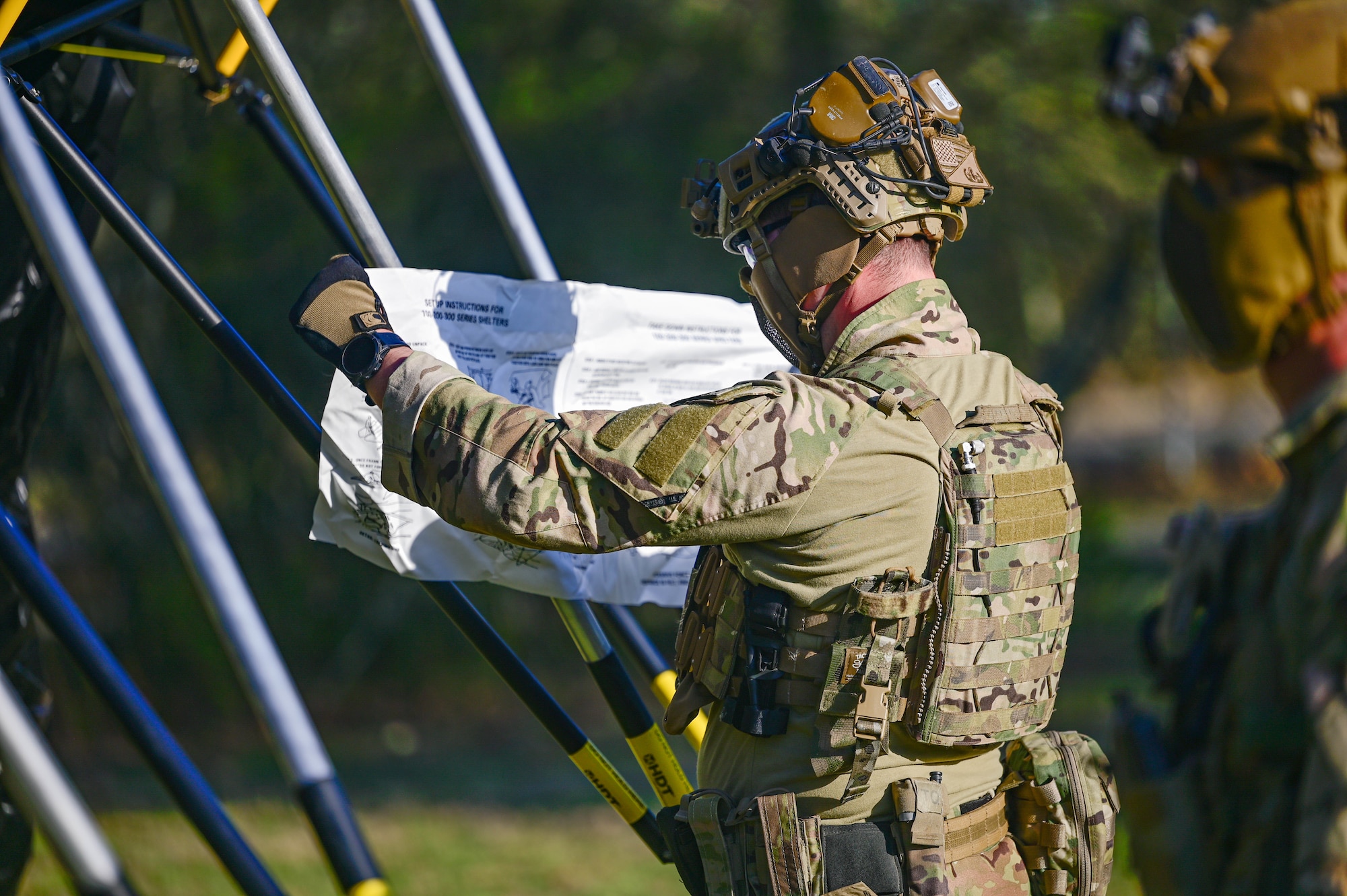An Airman assigned to the 19th Civil Engineer Squadron reviews instructions to assemble a Base-X tent during a Prime Base Engineer Emergency Force (Prime BEEF) field training exercise at Little Rock Air Force Base, Arkansas, March 19, 2025. Airmen refined their skills in defensive tactics to protect critical assets.