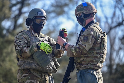 Airmen assigned to the 19th Civil Engineer Squadron exchange magazines during a Prime Base Engineer Emergency Force (Prime BEEF) field training exercise at Little Rock Air Force Base, Arkansas, March 19, 2025. This exercise ensured that bases can be established in hostile or remote locations.
