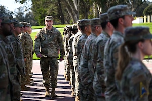A group of people stand outside in formation.