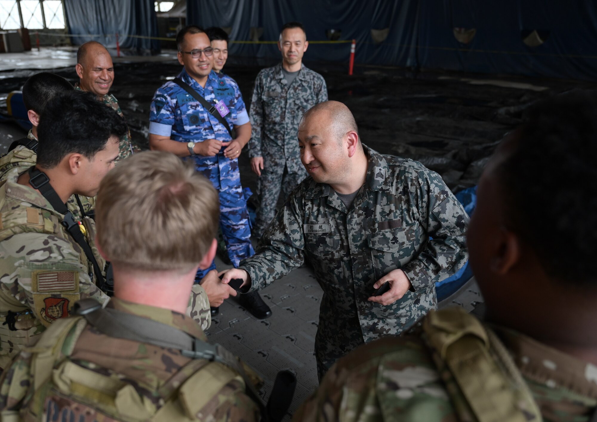 Japan Air Self-Defense Force presents a group of Airmen with patches.