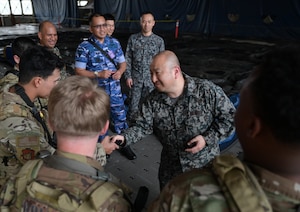 Japan Air Self-Defense Force presents a group of Airmen with patches.