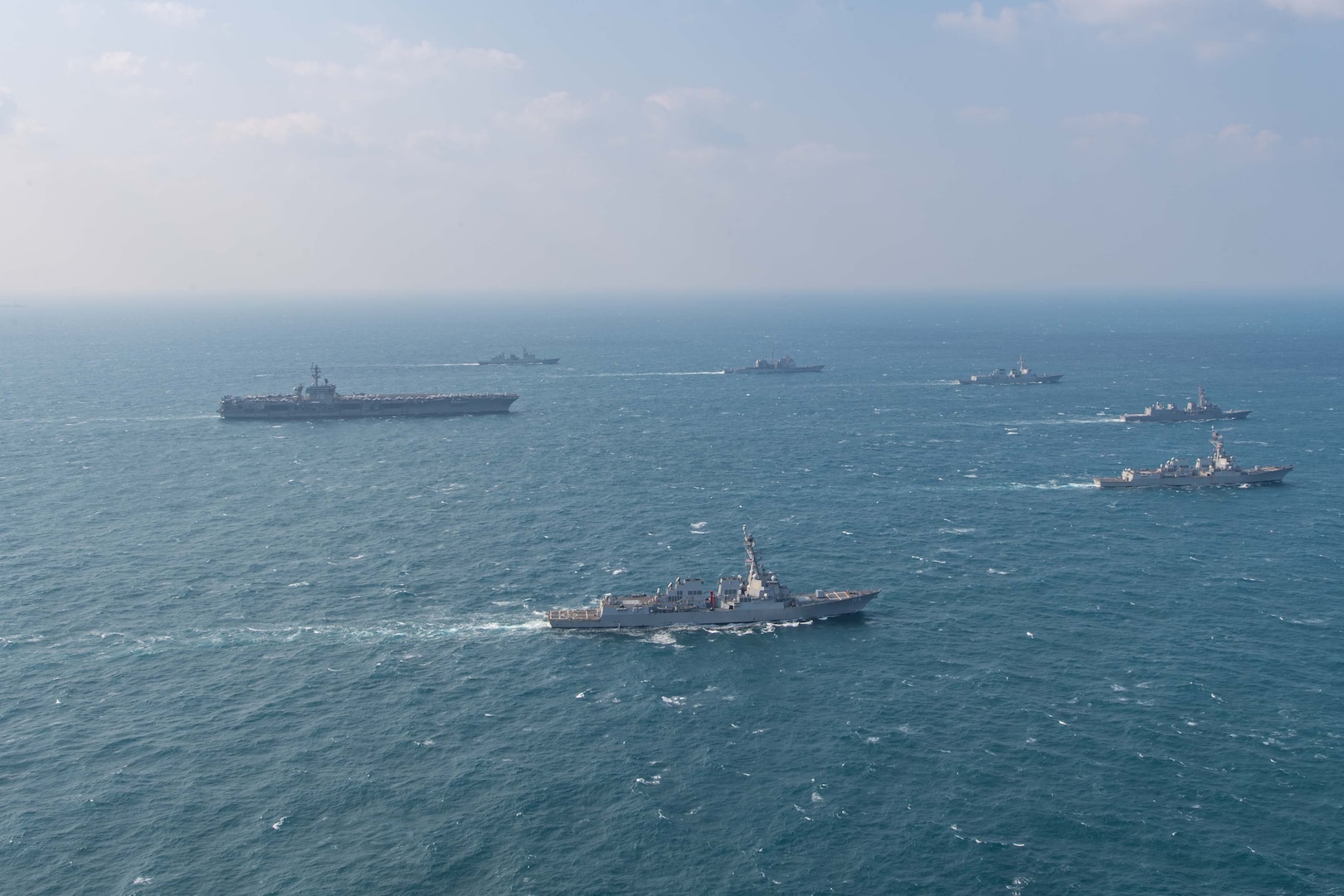 250318-N-GC571-1009 AT SEA (March 18, 2025) The Nimitz-class aircraft carrier USS Carl Vinson (CVN 70), left, sails in formation with the Ticonderoga-class guided-missile cruiser USS Princeton (CG 59), Arleigh Burke-class guided-missile destroyers USS Sterett (DDG 104) and USS Ralph Johnson (DDG 114), Sejong the Great-class destroyer ROKS Sejong the Great (DDG 991), Chungmugong Yi Sun-sin-class destroyer ROKS Dae Jo-yeong (DDH 977), and Murasame-class destroyer JS Ikazuchi (DD 107) at sea during a trilateral naval exercise, March 18, 2025. Trilateral exercises between the U.S. Navy, ROK Navy, and JMSDF continue to advance combined naval interoperability, ensure our militaries and self-defense forces can operate together against any threat, and demonstrate combined commitment to a secure and prosperous Indo-Pacific. (U.S. Navy photo by Mass Communication Specialist Seaman Apprentice Pablo Chavez)