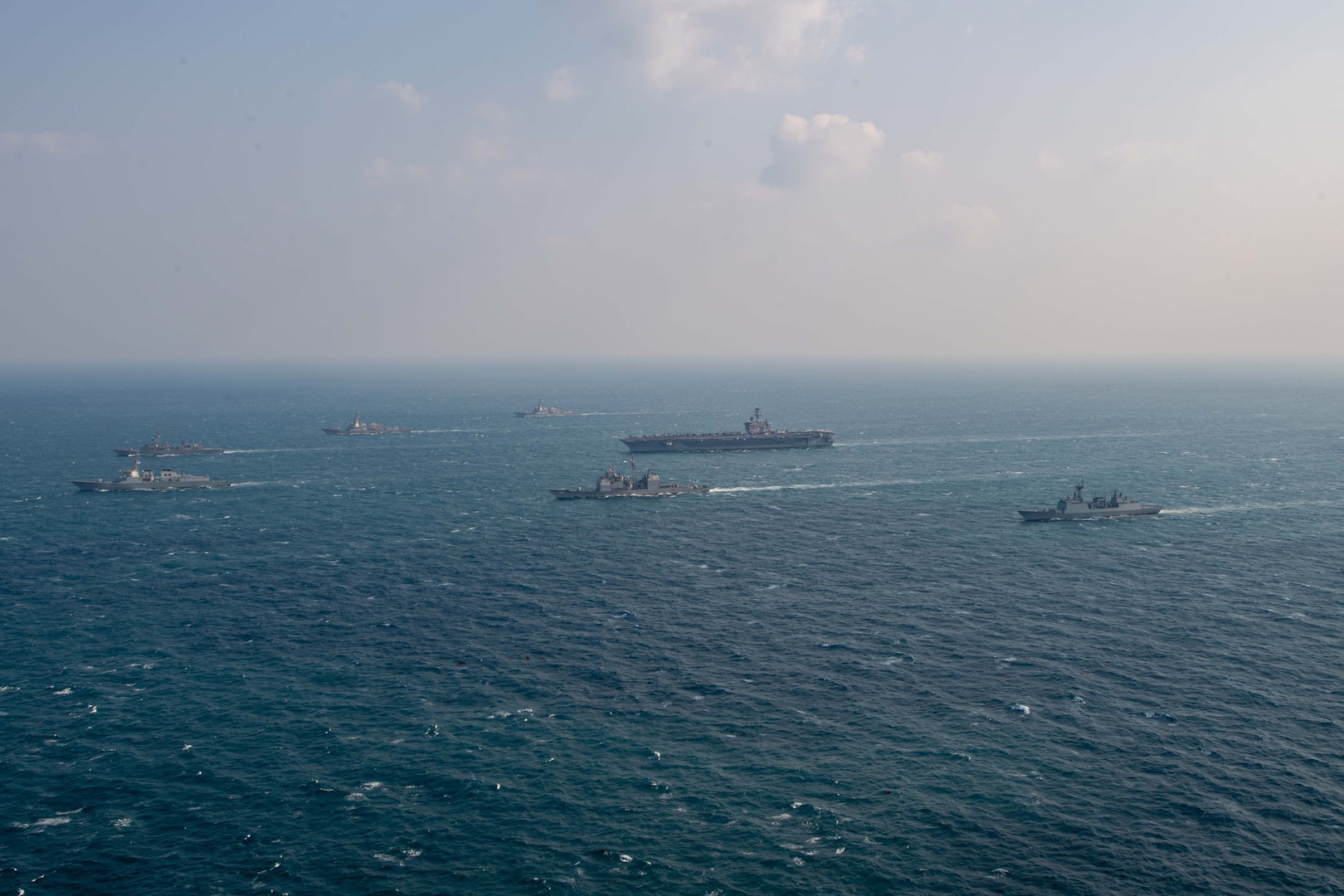 250318-N-GC571-1044 AT SEA (March 18, 2025) The Nimitz-class aircraft carrier USS Carl Vinson (CVN 70), center, sails in formation with the Ticonderoga-class guided-missile cruiser USS Princeton (CG 59), Arleigh Burke-class guided-missile destroyers USS Sterett (DDG 104) and USS Ralph Johnson (DDG 114), Sejong the Great-class destroyer ROKS Sejong the Great (DDG 991), Chungmugong Yi Sun-sin-class destroyer ROKS Dae Jo-yeong (DDH 977), and Murasame-class destroyer JS Ikazuchi (DD 107) at sea during a trilateral naval exercise, March 18, 2025. Trilateral exercises between the U.S. Navy, ROK Navy, and JMSDF continue to advance combined naval interoperability, ensure our militaries and self-defense forces can operate together against any threat, and demonstrate combined commitment to a secure and prosperous Indo-Pacific. (U.S. Navy photo by Mass Communication Specialist Seaman Apprentice Pablo Chavez)