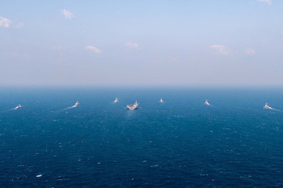 250318-N-GC571-1033 AT SEA (March 18, 2025) The Nimitz-class aircraft carrier USS Carl Vinson (CVN 70), center, sails in formation with the Ticonderoga-class guided-missile cruiser USS Princeton (CG 59), Arleigh Burke-class guided-missile destroyers USS Sterett (DDG 104) and USS Ralph Johnson (DDG 114), Sejong the Great-class destroyer ROKS Sejong the Great (DDG 991), Chungmugong Yi Sun-sin-class destroyer ROKS Dae Jo-yeong (DDH 977), and Murasame-class destroyer JS Ikazuchi (DD 107) at sea during a trilateral naval exercise, March 18, 2025. Trilateral exercises between the U.S. Navy, ROK Navy, and JMSDF continue to advance combined naval interoperability, ensure our militaries and self-defense forces can operate together against any threat, and demonstrate combined commitment to a secure and prosperous Indo-Pacific. (U.S. Navy photo by Mass Communication Specialist Seaman Apprentice Pablo Chavez)
