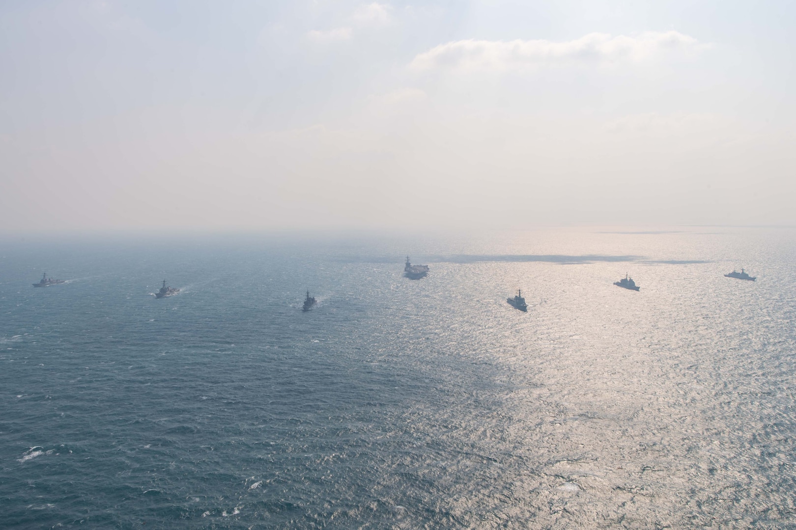 250318-N-GC571-1016 AT SEA (March 18, 2025) The Nimitz-class aircraft carrier USS Carl Vinson (CVN 70), center, sails in formation with the Ticonderoga-class guided-missile cruiser USS Princeton (CG 59), Arleigh Burke-class guided-missile destroyers USS Sterett (DDG 104) and USS Ralph Johnson (DDG 114), Sejong the Great-class destroyer ROKS Sejong the Great (DDG 991), Chungmugong Yi Sun-sin-class destroyer ROKS Dae Jo-yeong (DDH 977), and Murasame-class destroyer JS Ikazuchi (DD 107) at sea during a trilateral naval exercise, March 18, 2025. Trilateral exercises between the U.S. Navy, ROK Navy, and JMSDF continue to advance combined naval interoperability, ensure our militaries and self-defense forces can operate together against any threat, and demonstrate combined commitment to a secure and prosperous Indo-Pacific. (U.S. Navy photo by Mass Communication Specialist Seaman Apprentice Pablo Chavez)