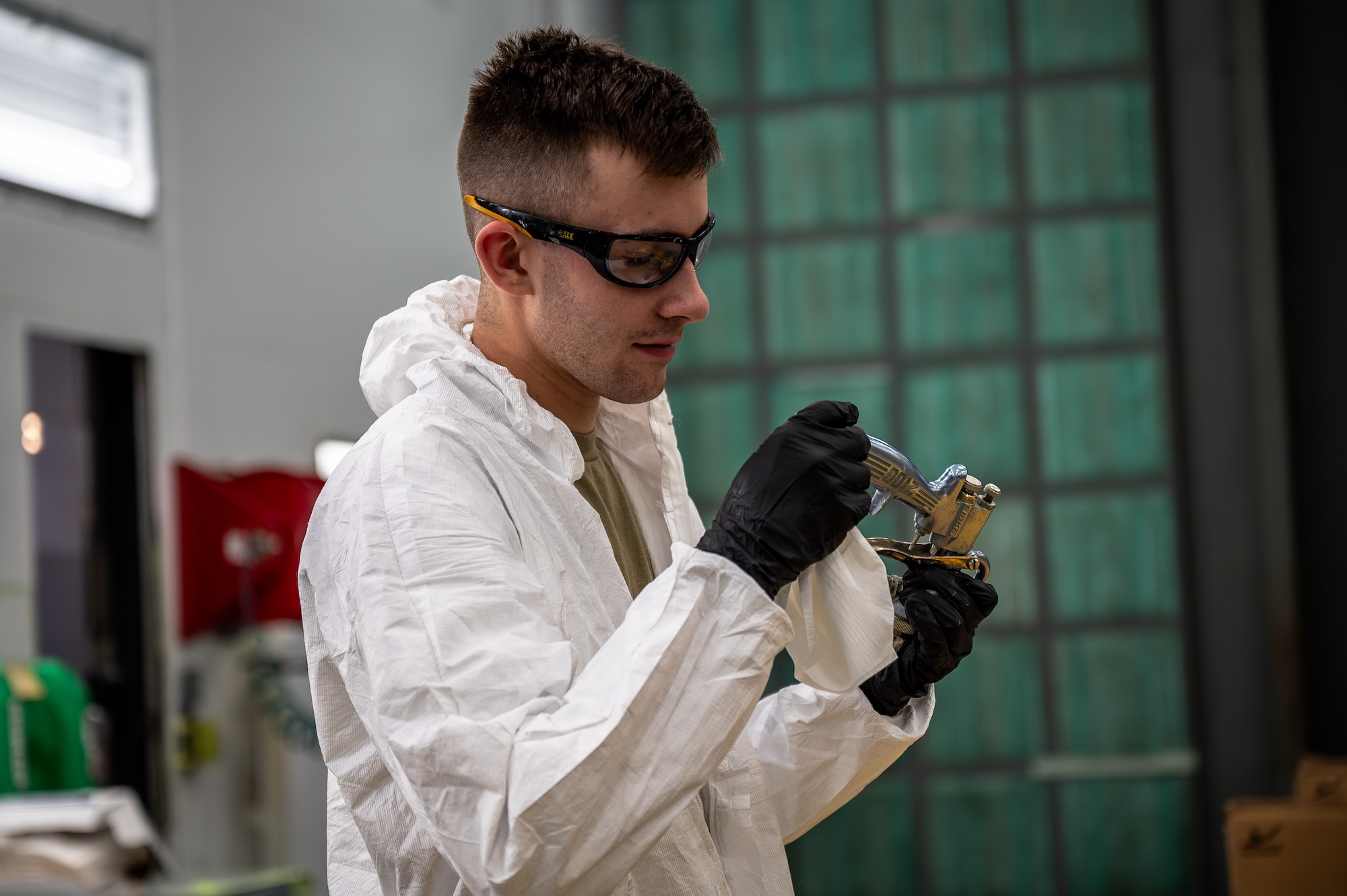 Person inspects painting tool