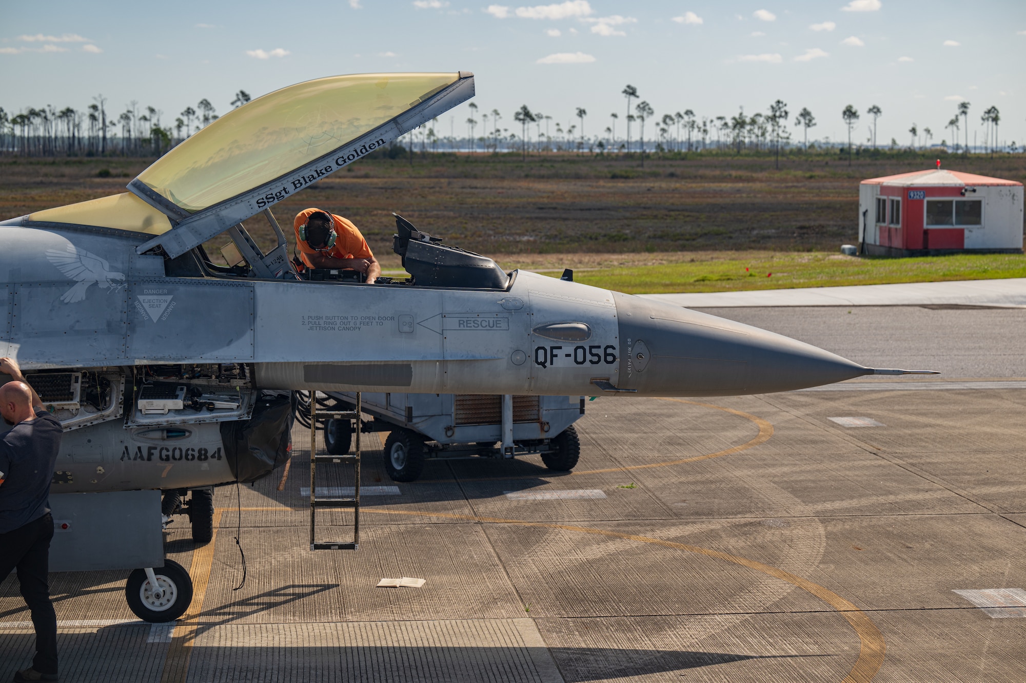 A contractor performs preflight maintenance on an aircraft