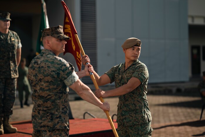 U.S. Marine Corps Capt. Louis Collins, left, a company commander with 1st Battalion, 5th Marine Regiment, attached to Marine Rotational Force-Southeast Asia, I Marine Expeditionary Force, and Singapore Guardsman Lt. Col. Mohamad Fahrul Bin Saaid, the commanding officer for 3rd Battalion Singapore Guards, pose for a photo during the opening ceremony for Valiant Mark 25 on Bedok Camp, Singapore, March 17, 2025. Valiant Mark is an annual, bilateral training exercise designed to enhance interoperability, build mutual defense capabilities, and strengthen military-to-military relationships between the U.S. Marine Corps and Singapore Armed Forces. MRF-SEA is a rotational unit derived from elements of I MEF executing a U.S. Marine Corps Forces, Pacific operational model that involves training events and exchanges with partner military subject matter experts, promotes security goals with Allied and partner nations, and ensures a persistent I MEF stand-in presence west of the international date line. (U.S. Marine Corps photo by Sgt. Shaina Jupiter)