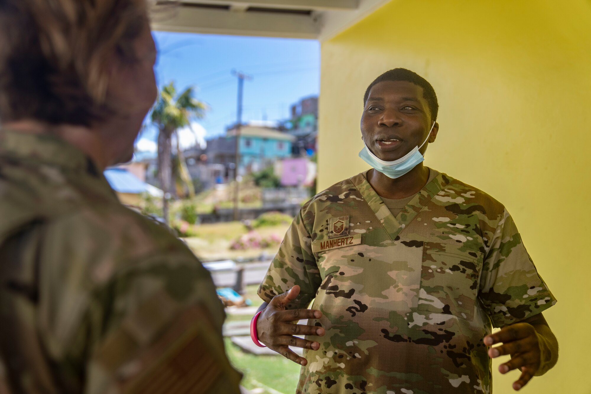 U.S. Air Force Master Sgt. Marvin Manhertz, 433rd Aerospace Medicine Squadron noncommissioned officer in charge of dental operations, talks to U.S. Air Force Brig. Gen. Tara Nolan, Mobilization Augmentee to the Air Forces Southern commander, during the Lesser Antilles Medical Assistance Team (LAMAT) mission at Canouan Island, Saint Vincent and the Grenadines, March 11, 2025. The LAMAT missions deploy medical teams to collaborate and partner with Saint Vincent medical professionals to deliver support and resources to the island nation and its healthcare system. (U.S. Air Force photo by Andrea Jenkins)
