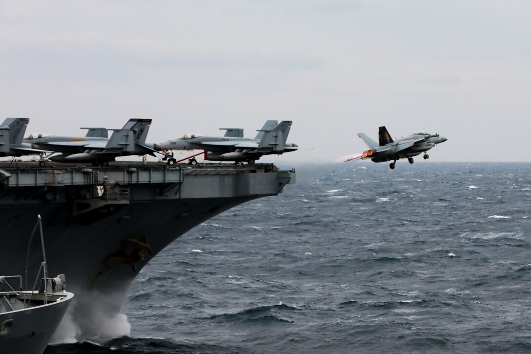 An EA-18G Growler, assigned to the “Gauntlets” of Electronic Attack Squadron (VAQ) 136 launches from the Nimitz-class aircraft carrier USS Carl Vinson (CVN 70) during a replenishment-at-sea with the Henry J. Kaiser-class underway replenishment oiler USNS Guadalupe (T-AO 200) and the Ticonderoga-class guided-missile cruiser USS Princeton (CG 59), March 15, 2025.