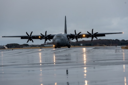 A C-130J Super Hercules taxis on runway.