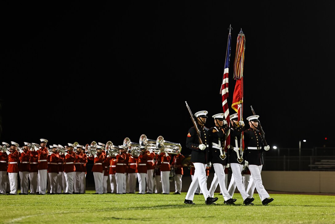 The Battle Color Detachment, consisting of "The Commandant's Own," the United States Marine Corps Silent Drill Platoon, and the United States Marine Corps Color Guard, performs in the United States Marine Corps Battle Color Ceremony at Kofa Kigh School in Yuma, AZ, Feb. 28, 2025. The Battle Color Detachment showcases the pride, professionalism, and esprit de corps that are hallmarks of the United States Marines. (U.S. Marine Corps photo by LCpl Prelle)