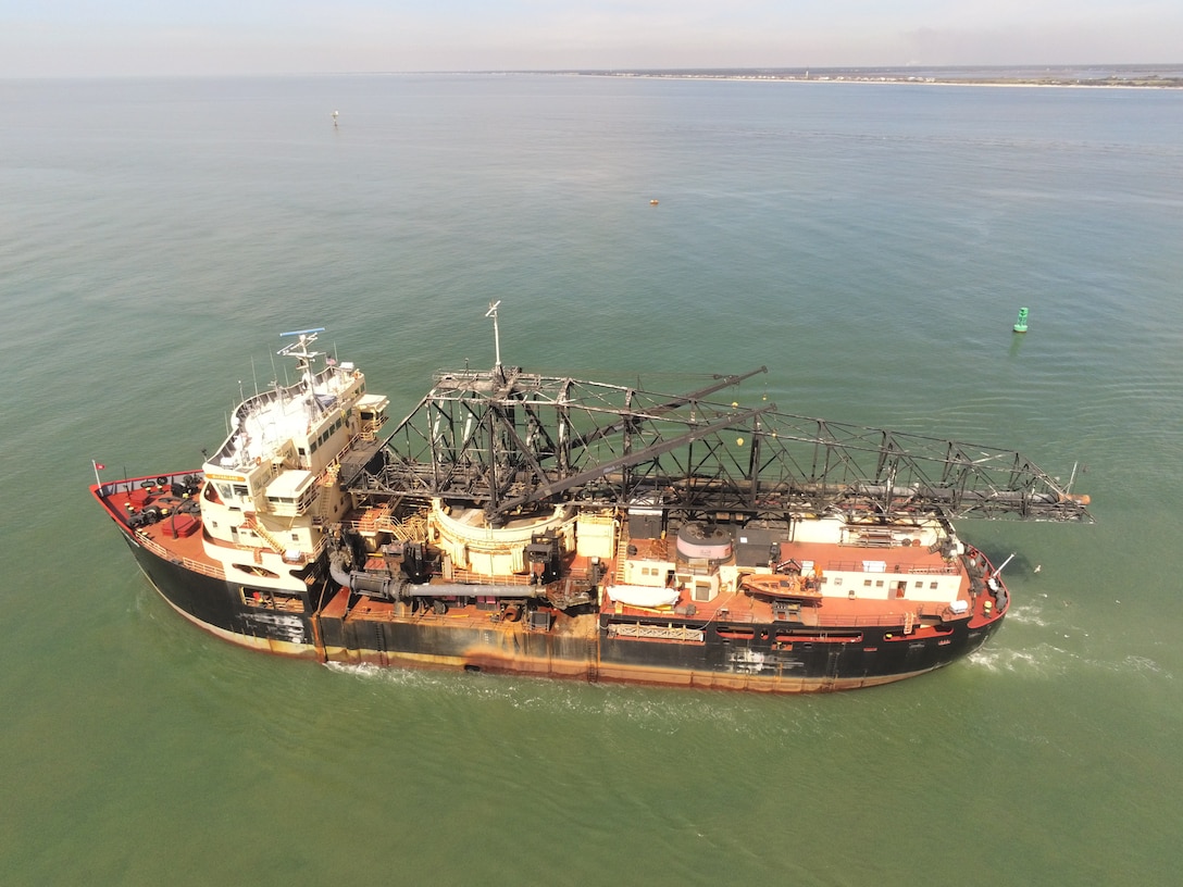 The Dredge McFarland, owned and operated by the U.S. Army Corps of Engineers Philadelphia District, conducts an urgent dredging mission near the entrance of the Cape Fear River in North Carolina.