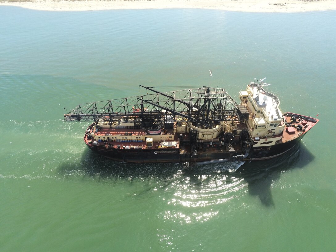 The Dredge McFarland, owned and operated by the U.S. Army Corps of Engineers Philadelphia District, conducts an urgent dredging mission near the entrance of the Cape Fear River in North Carolina.
