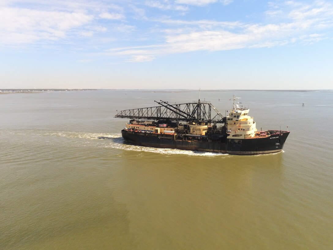 The Dredge McFarland, owned and operated by the U.S. Army Corps of Engineers Philadelphia District, conducts an urgent dredging mission near the entrance of the Cape Fear River in North Carolina.