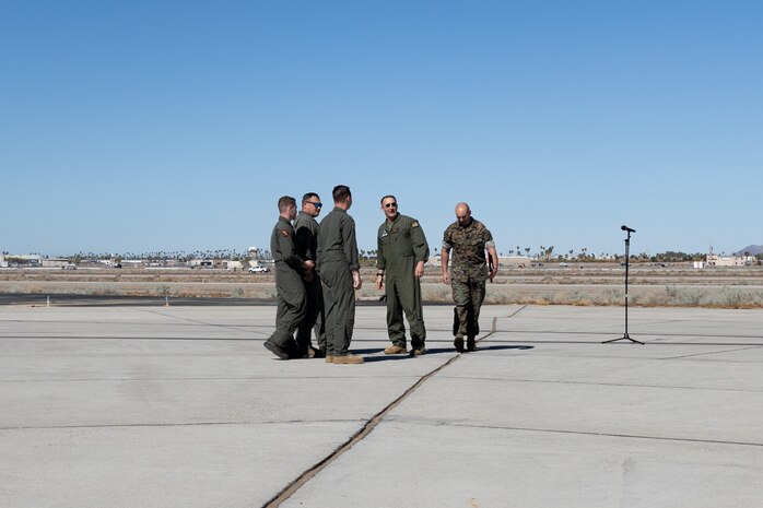 U.S. Marine Corps Col. Jared K. Stone, commanding officer, and Sgt. Maj. Jason A. Davey, sergeant major, Marine Corps Air Station (MCAS) Yuma, recognize the CH-53K King Stallion pilots and crew with Marine Operational and Test Evaluation Squadron (VMX) 1, during the opening ceremony of the Yuma Airshow at Marine Corps Air Station Yuma, Arizona, March 15, 2025. The pilots and crew were commended for their heroic efforts, demonstrating Marines capability to react to practical situations, the crew identified an injured motorcyclist while on a flight and provided a medical evacuation back to MCAS Yuma. (U.S. Marine Corps photo by Cpl. Jade K. Venegas)