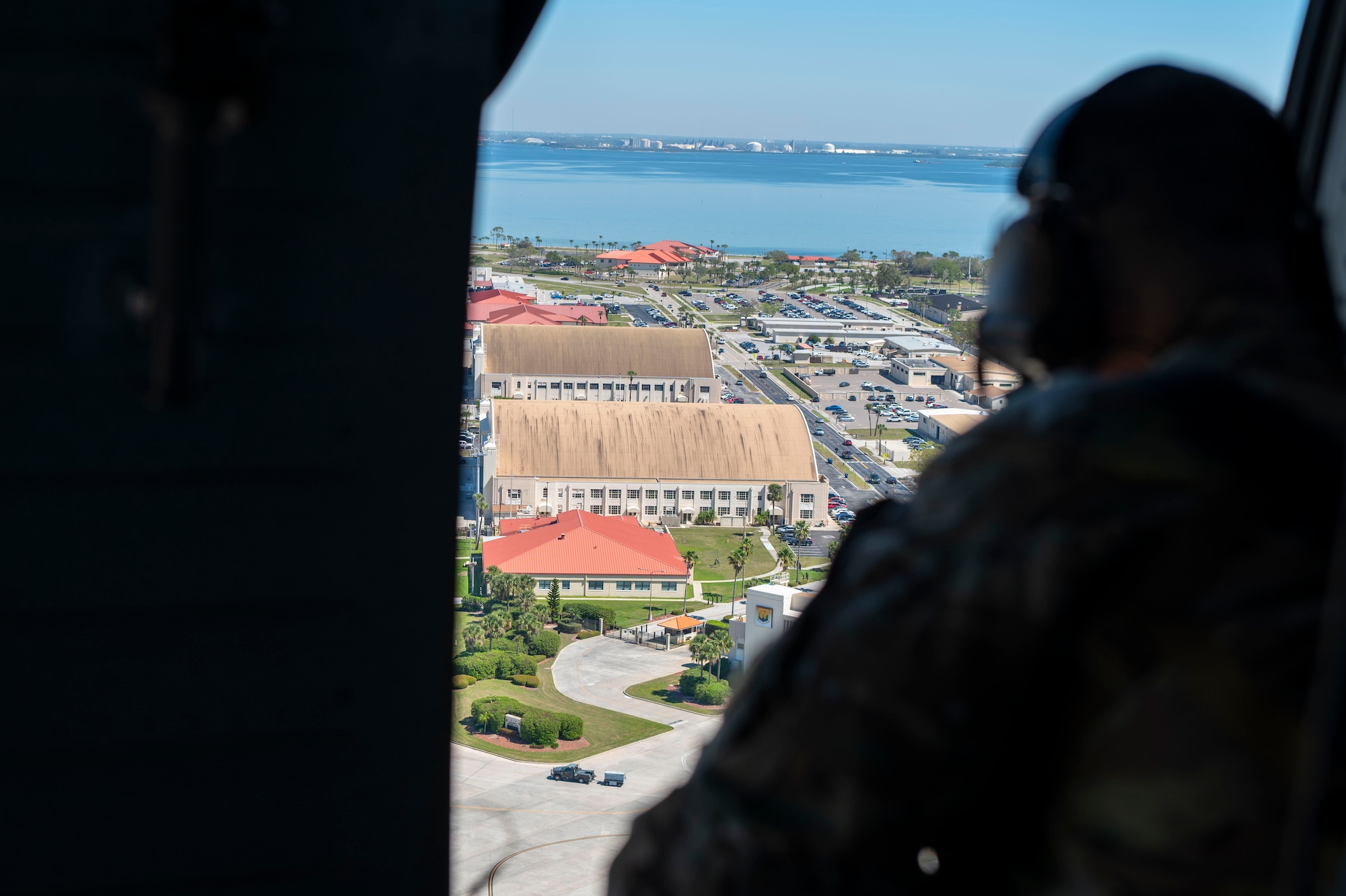 U.S. Air Force Tech. Sgt. Joseph Villano, 6th Security Forces Squadron Coastal Observation Aerial Security Team program manager surveys MacDill Air Base from a UH-60 Black Hawk assigned to the 5th Army Reserve Battalion-159th Aviation Regiment March 7, 2025.