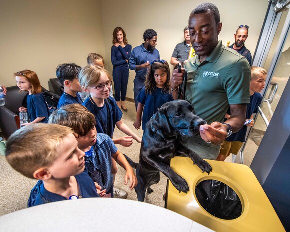 NCIS special agent and K-9 Jill hold demonstration for school-aged children.