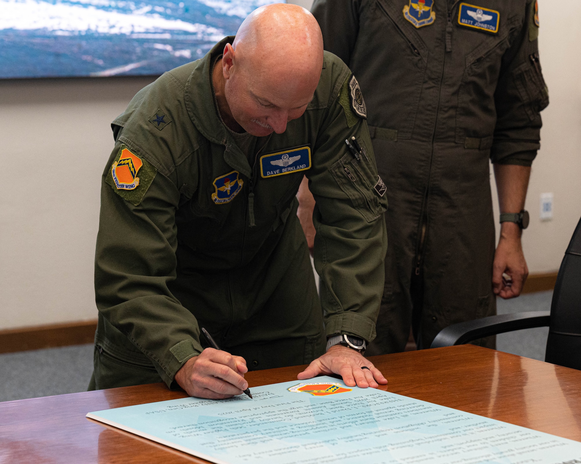 U.S. Air Force Brig. Gen. David Berkland, 56th Fighter Wing commander, signs a proclamation consecrating the month of April as Sexual Assault Awareness and Prevention Month, March 20, 2025, at Luke Air Force Base, Arizona.