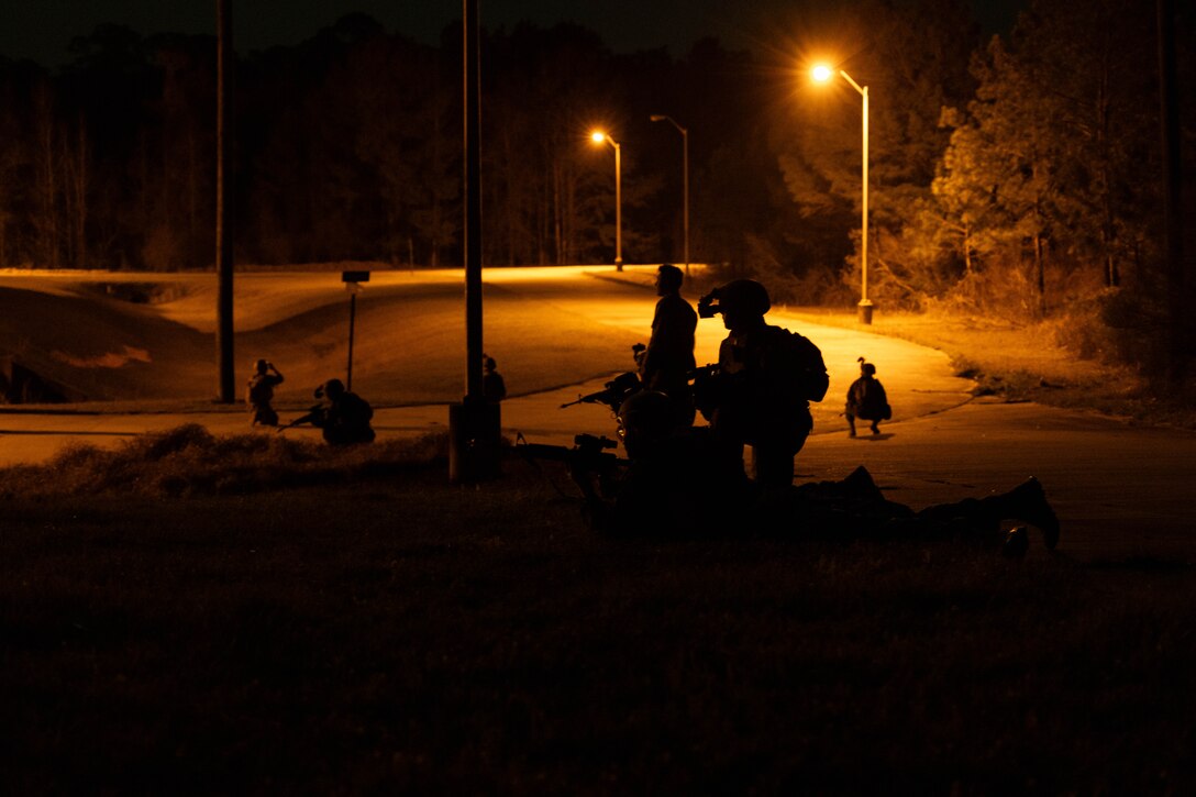 U.S. Marines with Marine Forces Reserve patrol through a simulated town during a field exercise on Camp Shelby Joint Forces Training Center, Mississippi, March 11, 2025. MARFORRES Marines conducted the exercise to maintain proficiency in warfighting, communication and leadership skills common to all Marines. (U.S. Marine Corps photo by Lance Cpl. Van Hoang)