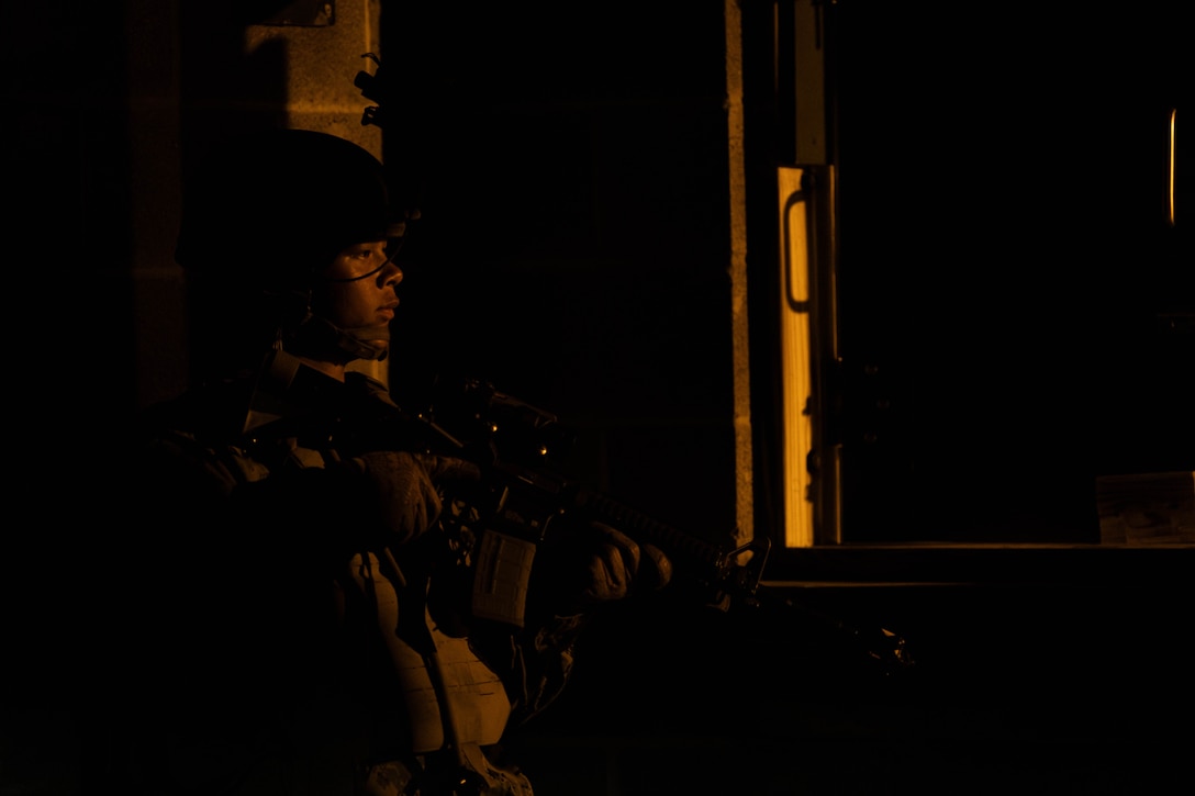 U.S. Marine Corps Lance Cpl. Andrew Nguyen, an administrative clerk with Marine Forces Reserve, defends a building during a field exercise on Camp Shelby Joint Forces Training Center, Mississippi, March 13, 2025. MARFORRES Marines conducted the exercise to maintain proficiency in warfighting, communication and leadership skills common to all Marines. (U.S. Marine Corps photo by Lance Cpl. Van Hoang)