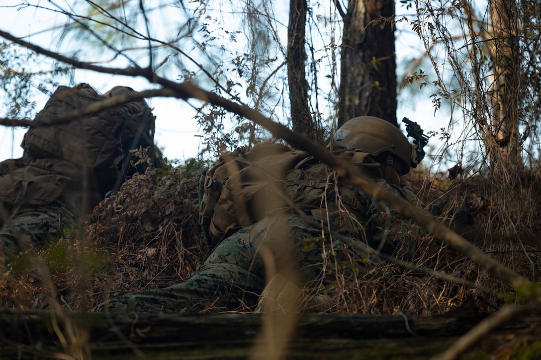 U.S. Marine Corps Lance Cpl. Cienna Magwood, a unit diary clerk with Marine Forces Reserve, prepares to suppress enemies with a M4 carbine for an assault on a town during a field exercise on Camp Shelby Joint Forces Training Center, Mississippi, March 11, 2025. MARFORRES Marines conducted the exercise to maintain proficiency in warfighting, communication and leadership skills common to all Marines. (U.S. Marine Corps photo by Lance Cpl. Van Hoang)