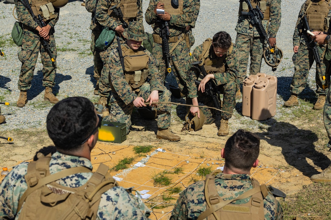 U.S. Marine Corps Sgt. Mark Zemskal, a maintenance management specialist with Marine Forces Reserve, briefs Marines for an assault on a village during a field exercise on Camp Shelby Joint Forces Training Center, Mississippi, March 12, 2025. MARFORRES Marines conducted the exercise to maintain proficiency in warfighting, communication and leadership skills common to all Marines. (U.S. Marine Corps photo by Lance Cpl. Van Hoang)