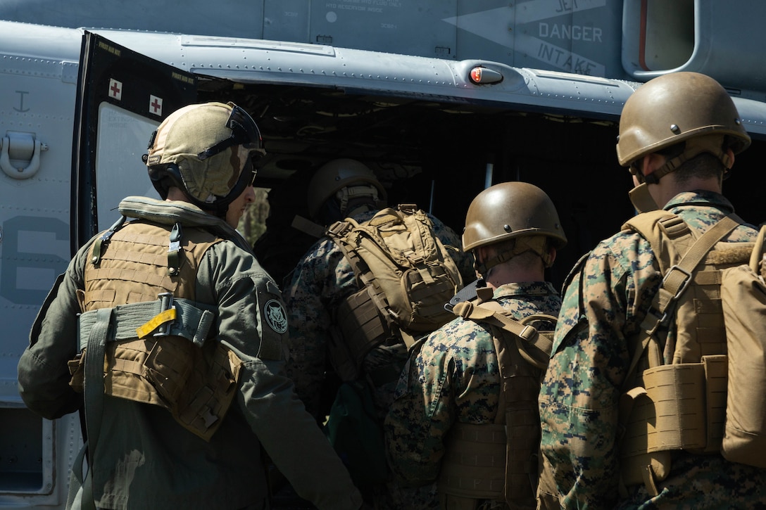 U.S. Marines with Marine Forces Reserve board a UH-1Y Venom utility helicopter during a field exercise on Camp Shelby Joint Forces Training Center, Mississippi, March 12, 2025. MARFORRES Marines conducted the exercise to maintain proficiency in warfighting, communication and leadership skills common to all Marines. (U.S. Marine Corps photo by Lance Cpl. Van Hoang)