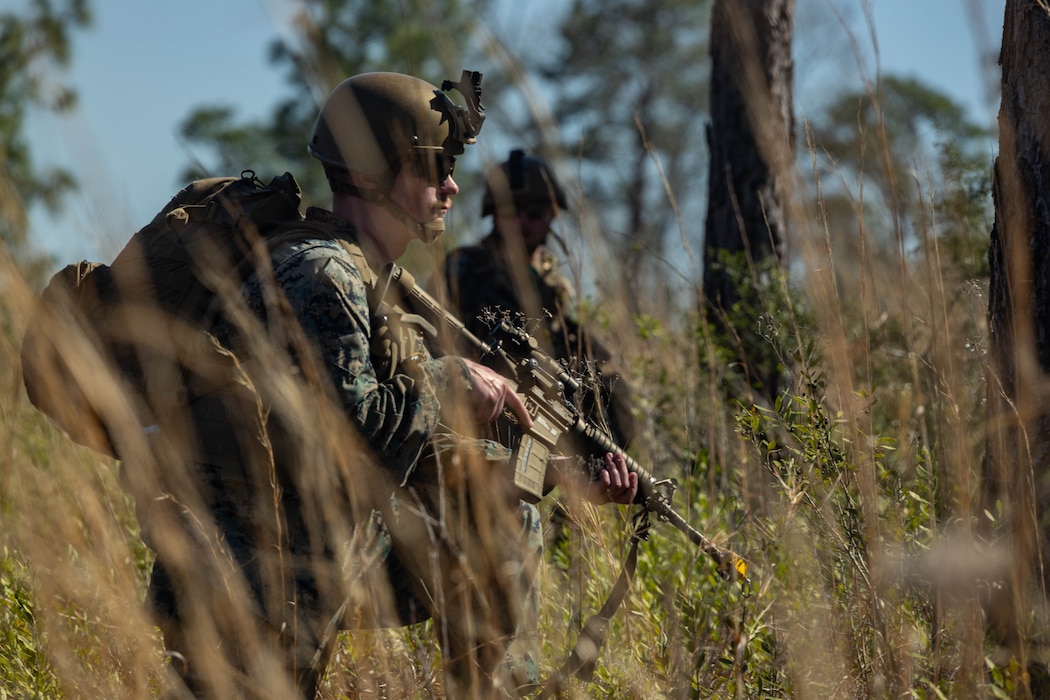 U.S. Marine Corps Cpl. Tyrese Richard, an intelligence analyst with Marine Forces Reserve, takes a knee during a patrol and awaits further instruction during a field exercise on Camp Shelby Joint Forces Training Center, Mississippi, March 10, 2025. MARFORRES Marines conducted the exercise to maintain proficiency in warfighting, communication and leadership skills common to all Marines. (U.S. Marine Corps photo by Lance Cpl. Van Hoang)