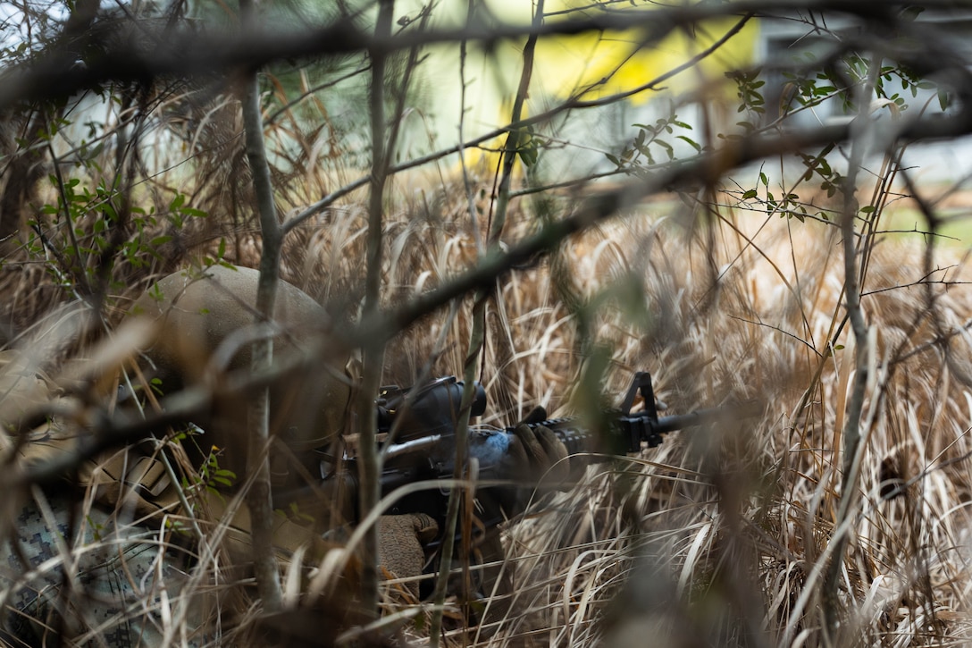 U.S. Marine Corps Cpl. Erick Campoy, a financial management resource analyst with Marine Forces Reserve, fires an M4 carbine at simulated enemies in a village during a field exercise on Camp Shelby Joint Forces Training Center, March 13, 2025. MARFORRES Marines conducted the exercise to maintain proficiency in warfighting, communication and leadership skills common to all Marines. (U.S. Marine Corps photo by Lance Cpl. Van Hoang)